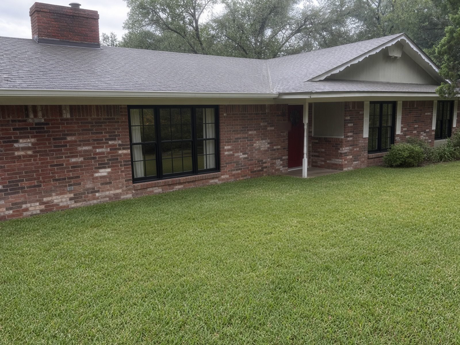 After: brick ranch home with new Renewal by Andersen windows