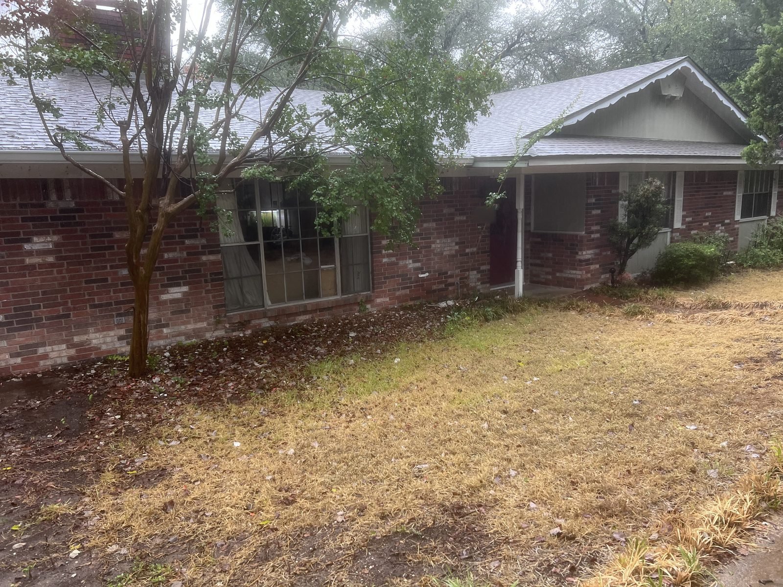 Before: brick ranch home with original windows